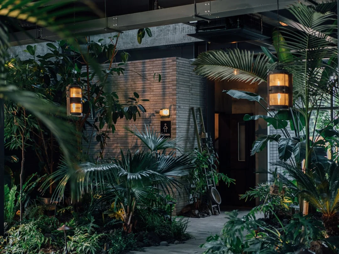 a building with a bunch of plants in front of it. related to The Layered Approach to Biophilic Interior Design: How Natural Elements Improve Your Home Without Turning It Into a Jungle