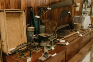 a collection of old tools on a wooden shelf. related to Authentic Vintage vs. Reproduction: How to Spot Real Vintage Accessories and Build a Cohesive Collection