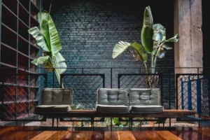 a couple of couches sitting on top of a wooden floor. related to Industrial Home Design Without the Cold Warehouse Feel: A Practical Guide