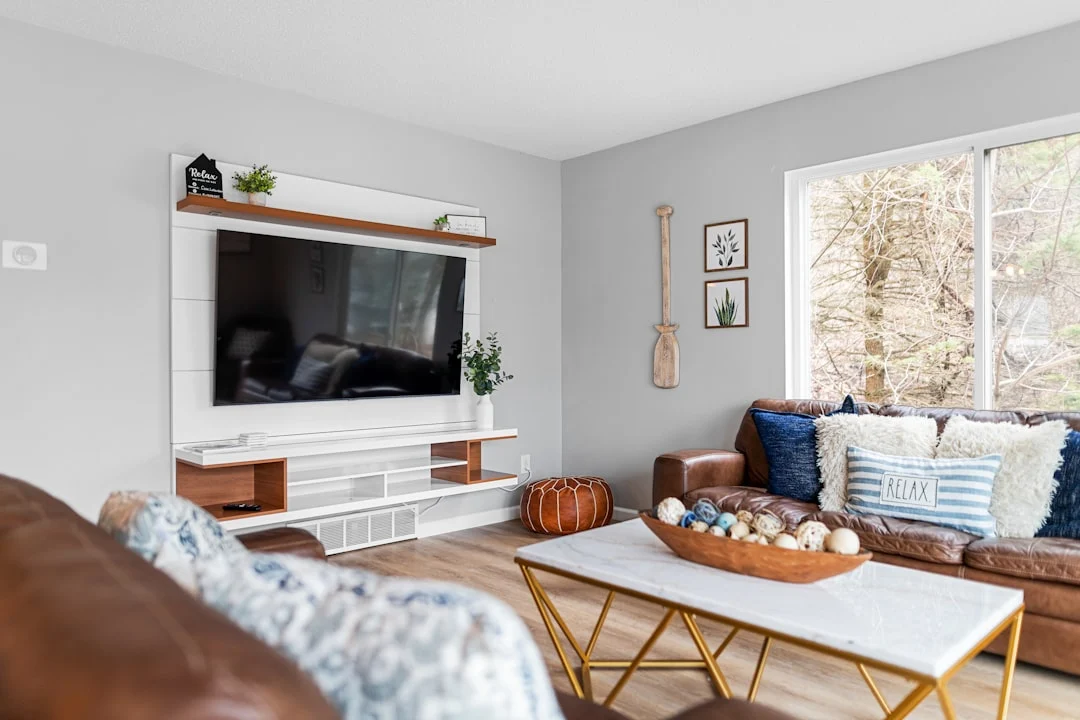 a living room filled with furniture and a flat screen tv. related to Small Changes, Big Impact: How Intentional Layering Creates a Cozy Living Room on a Budget