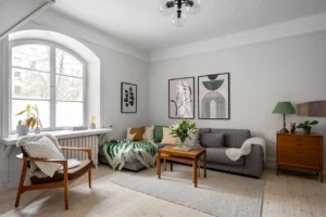 A living room filled with furniture and a large window. related to Warm Scandinavian Decor: How to Make Minimalist Nordic Interiors Feel Lived-In (Not Sterile)
