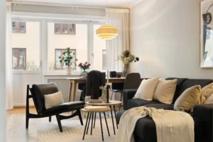 A living room filled with furniture and a large window. related to Warm Scandinavian Decor: How to Make Minimalist Nordic Interiors Feel Lived-In (Not Sterile)