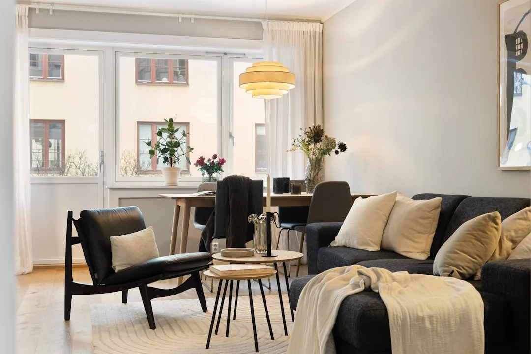 A living room filled with furniture and a large window. related to Warm Scandinavian Decor: How to Make Minimalist Nordic Interiors Feel Lived-In (Not Sterile)