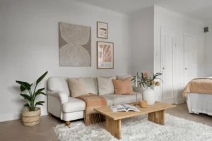 A living room filled with furniture and a white rug. related to Neutral Room Decor Is a Layered System of Warm, Cool & Earth Tones