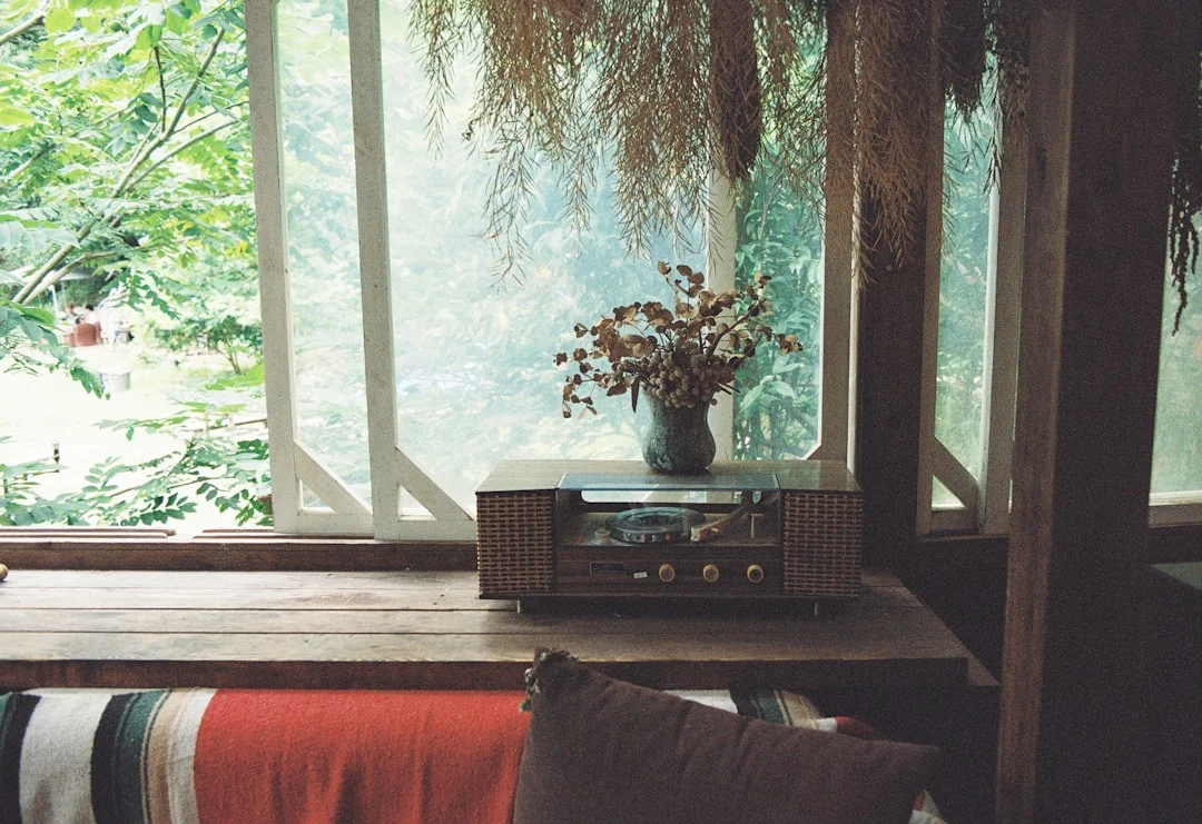 a table with a radio and a vase of flowers on top of it. related to Sustainable Home Decor That Doesn't Look Rustic: A Modern Guide to Eco-Friendly Interiors