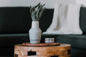black metal candle holder on brown wooden table. related to Small Changes, Big Impact: How Intentional Layering Creates a Cozy Living Room on a Budget