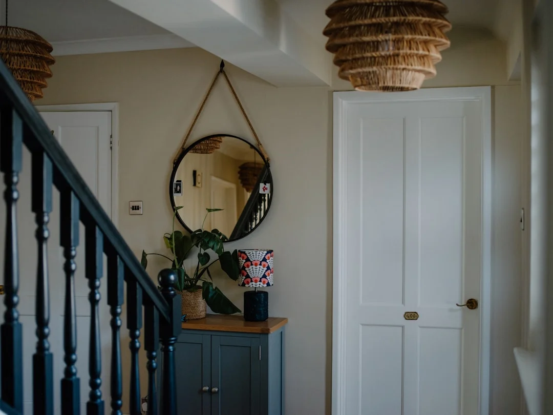 Hallway with staircase, mirror, and cabinet.. related to Style Your Entryway Table to Match How You Actually Use It