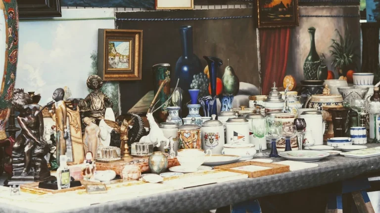 a table topped with lots of different types of vases. related to Authentic Vintage vs. Reproduction: How to Spot Real Vintage Accessories and Build a Cohesive Collection