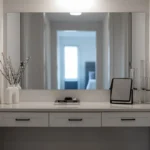 A modern vanity table with a large mirror and decor.. related to Style Your Entryway Table to Match How You Actually Use It