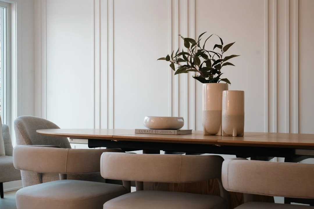 Modern dining room with oval table and chairs.. related to How to Choose a Dining Room Centerpiece That Doesn't Block Your View
