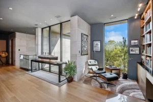Modern living room with large windows and bookshelves. related to How to Create an Authentic Mid-Century Modern Home Without Buying Expensive Originals