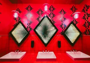 Three diamond-shaped mirrors with infinity lights above sinks.. related to Bathroom Wall Art That Survives Moisture and Matches Your Fixtures